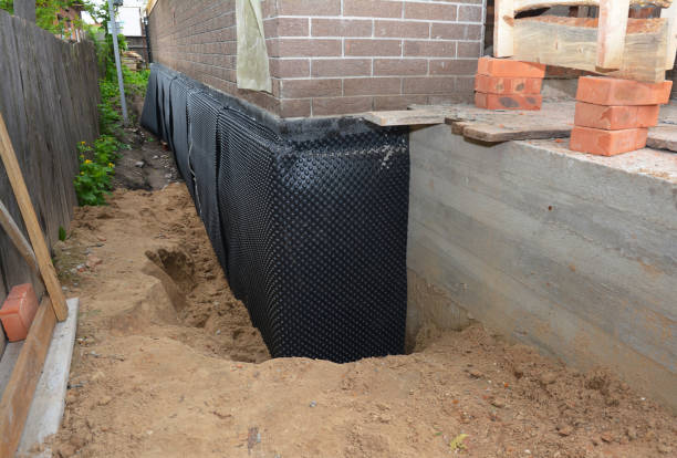 Happy homeowners after waterproofing job in Bitely